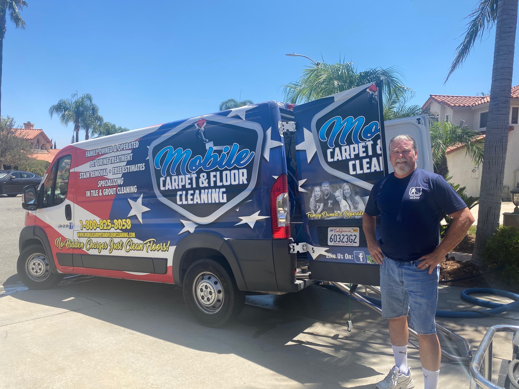 Carpet cleaning company owner standing beside a truck-mounted cleaning system.