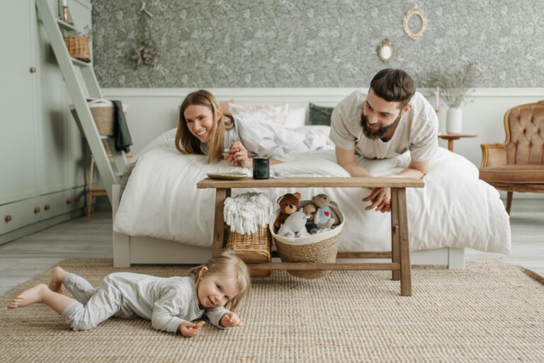 Happy family playing on an allergen-free rug in a clean Eastvale, CA home after professional carpet sanitation