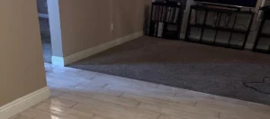 Freshly cleaned tile and carpet flooring side by side in a Chino Hills living room after professional cleaning